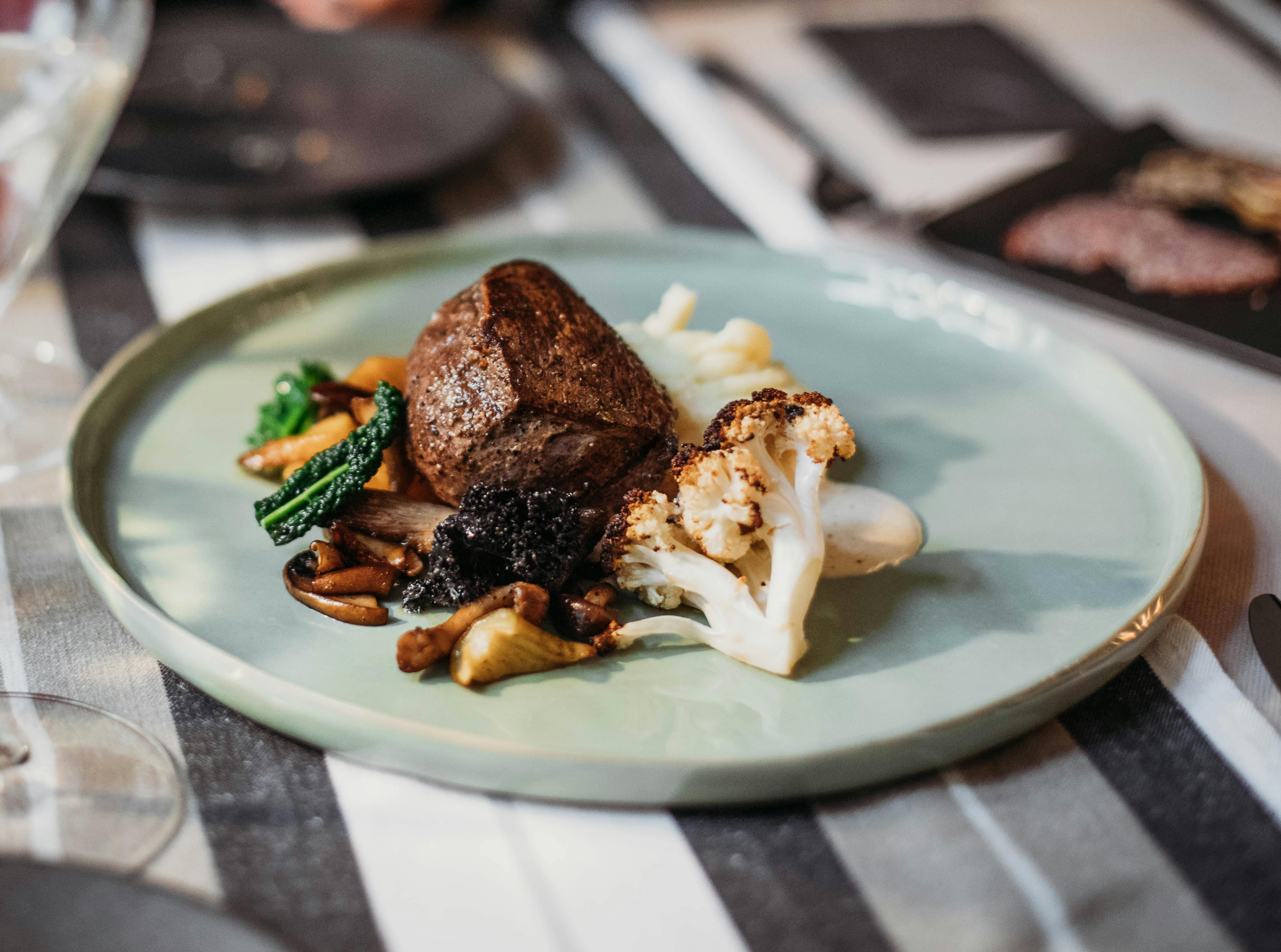 Beef filet with sides of mushrooms and cauliflower